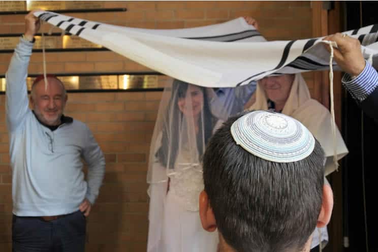Jewish wedding ceremony holding the cloth above the bride and groom