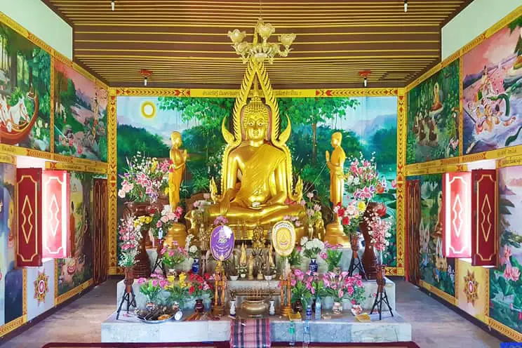 Buddhist temple with large gold Buddha statue in the center