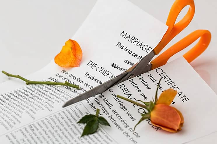 Wedding contract certificate cut by scissors.