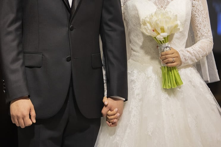 Wedding couple with bride holding flowers
