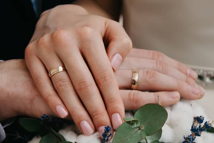 Jewish couple with hands on each other hands wearing gold rings